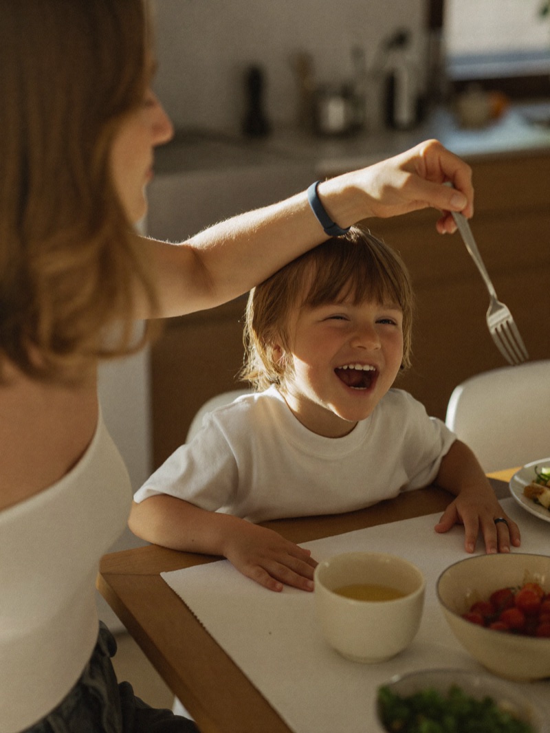 A parent and child laughing together at home